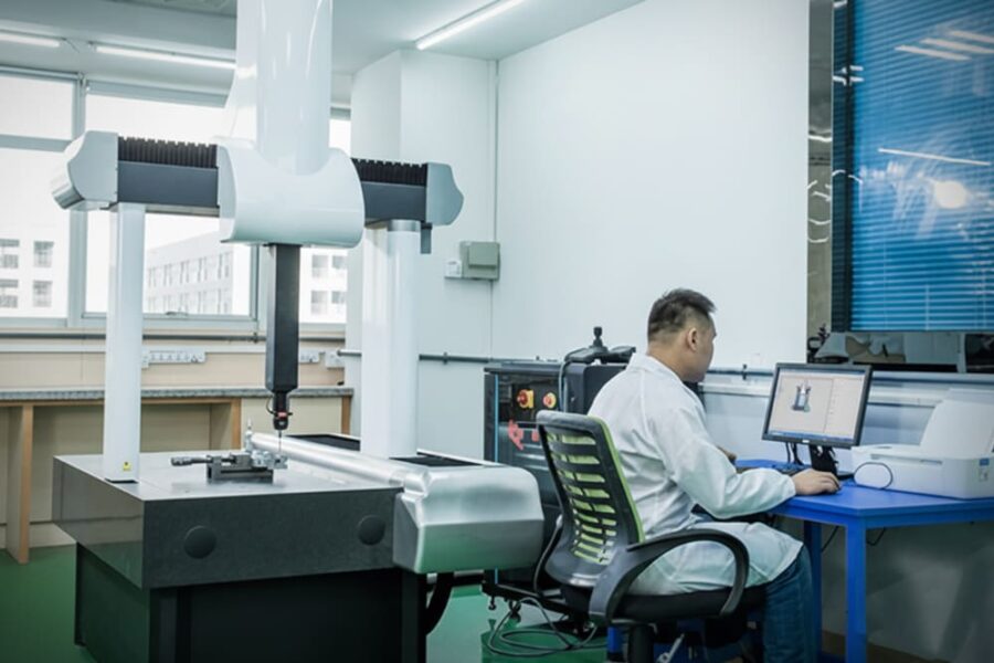 Smart Drive engineering expert using precision CMM equipment to evaluate custom motor specifications, ready for your project inquiry.