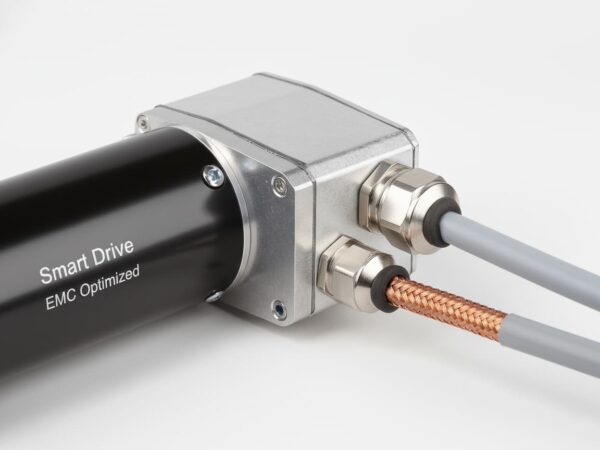 Custom automotive BLDC motor by IHS Smart Drive featuring a metal junction box and exposed braided shielding cable, demonstrating EMC-compliant architecture for CISPR 25 standards.